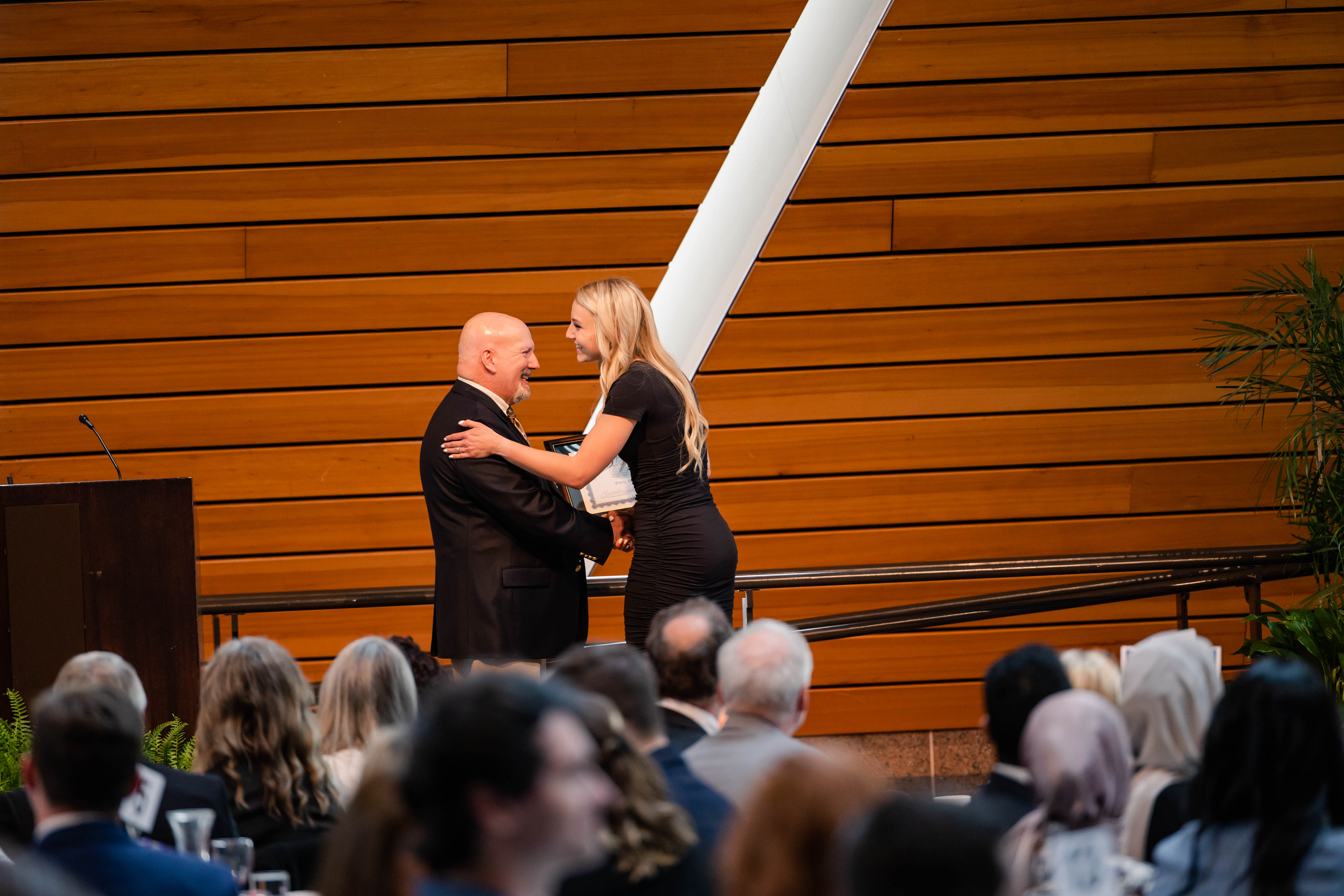 A student receives an award from a presenter
