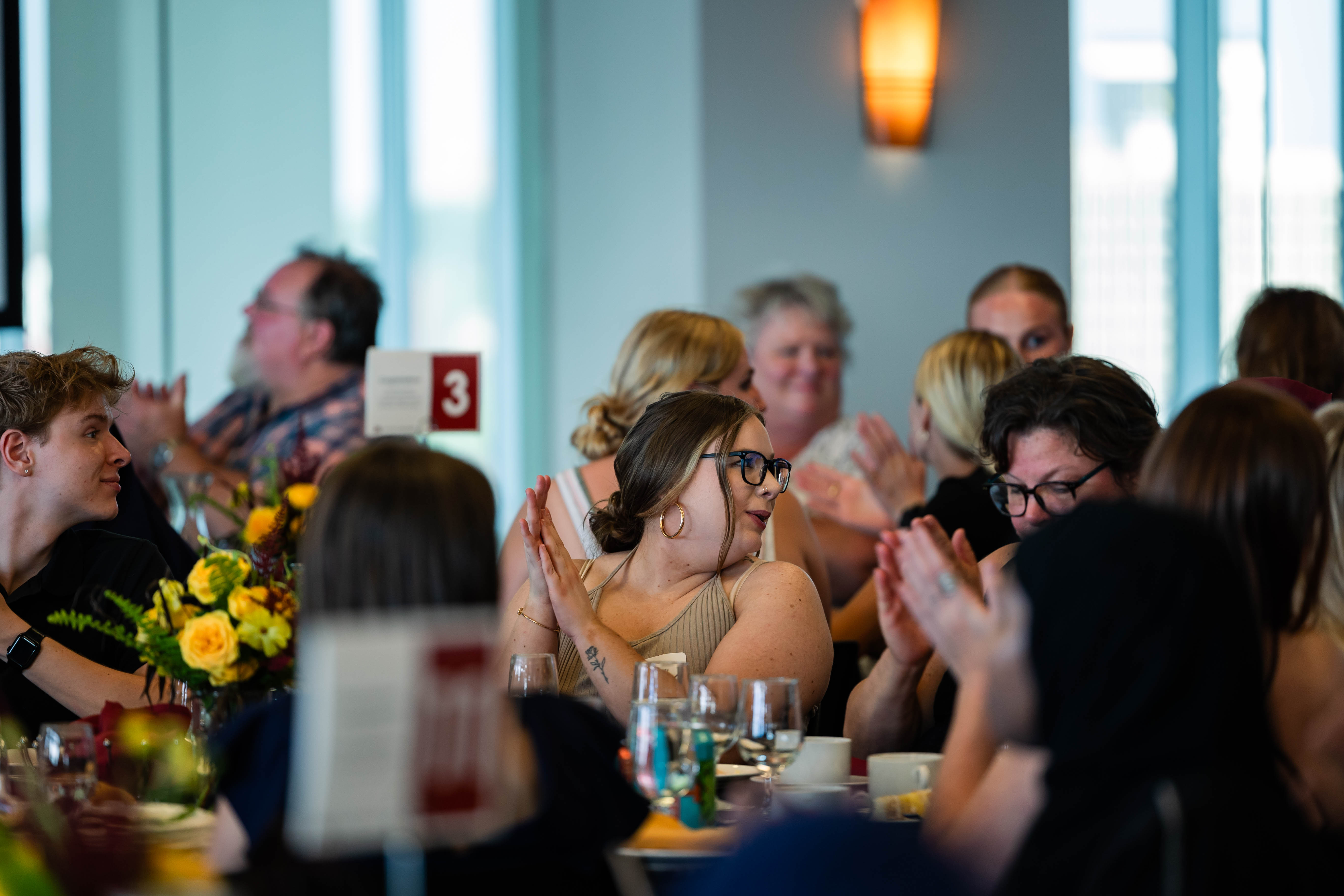 Attendees smile and applaud