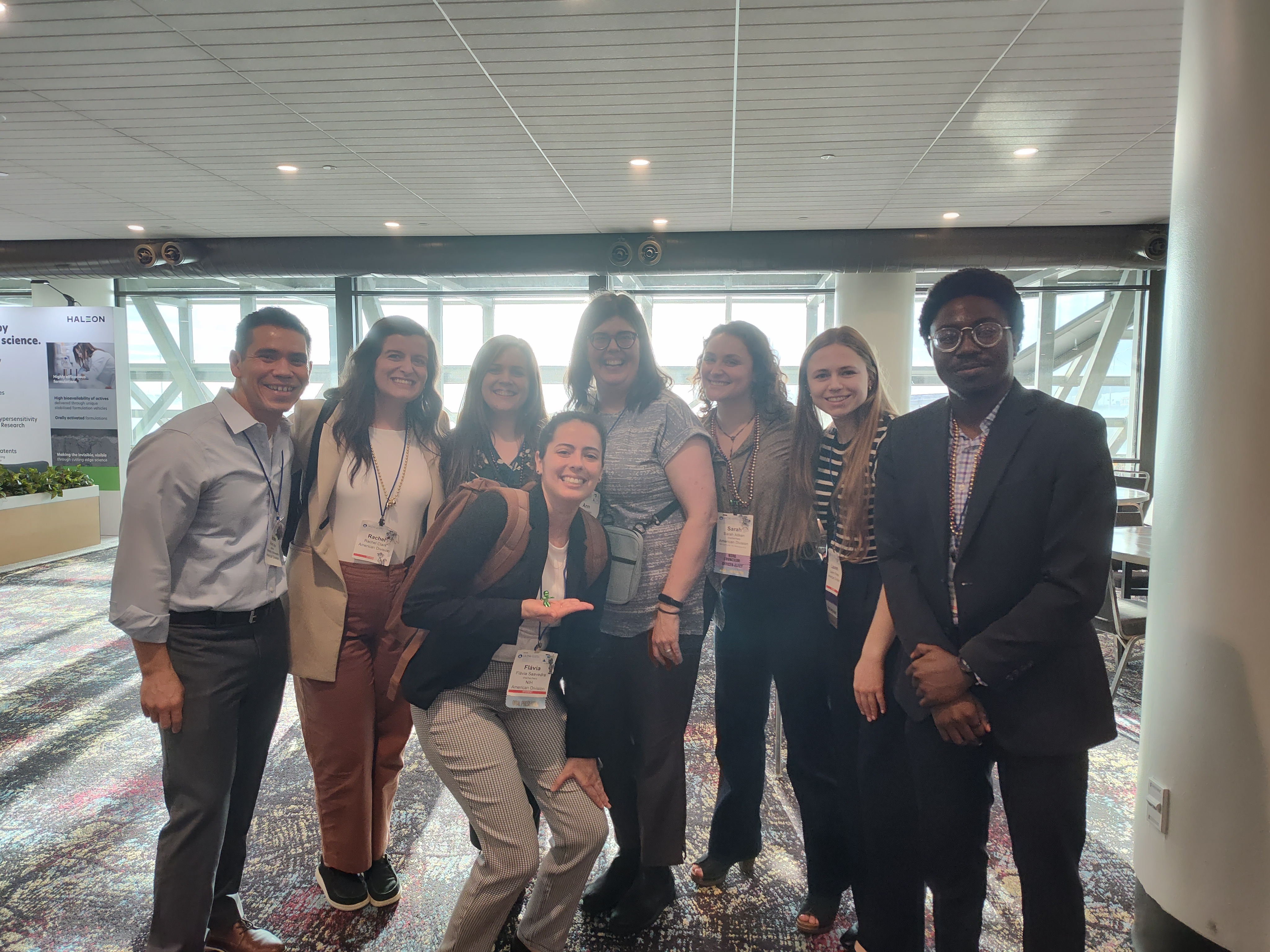School of Dentistry members smiling at AADOCR showcase.