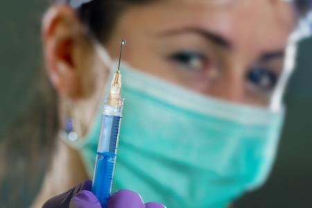 Dental professional with oral anesthetic injection