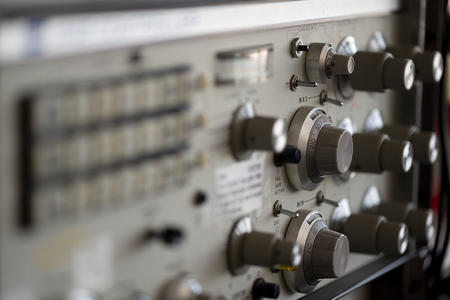 piece of lab equipment with many knobs and switches