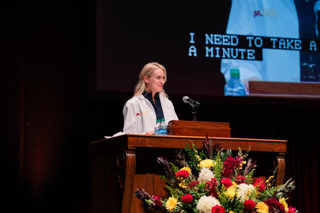 Janelle Jehn speaks at a podium