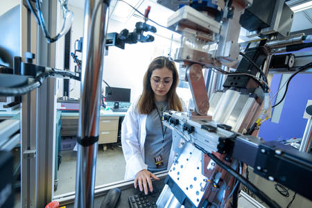 a researcher types in code to operate the chewing robot lab tech