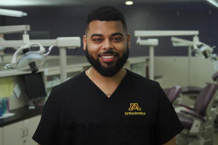 Kaimen Obeng smiles at the camera in the Orthodontics clinic