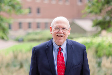 Stephen Shuman standing outside smiling.