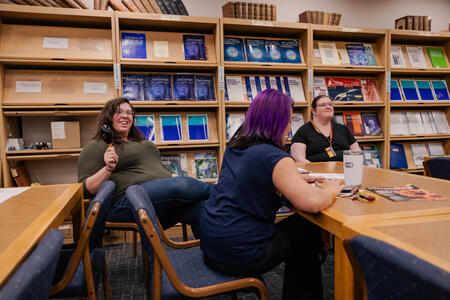 Staff members smile as they enjoy musical instruments and color.