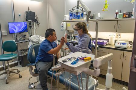 A patient and provider high five after treatment