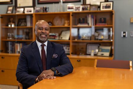 Dean Mays sits at his conference table and smiles