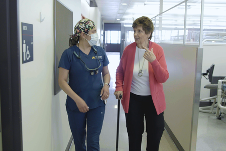 Jessie Walsh and Linda Marlin walk down the clinic hallway