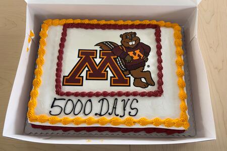 A sheet cake includes the University of Minnesota logo and says "5000 days"