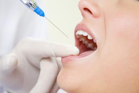 Patient receiving an oral local anesthesia injection