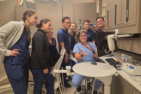 Uppgaard presents to a group of DDS students in a clinic space
