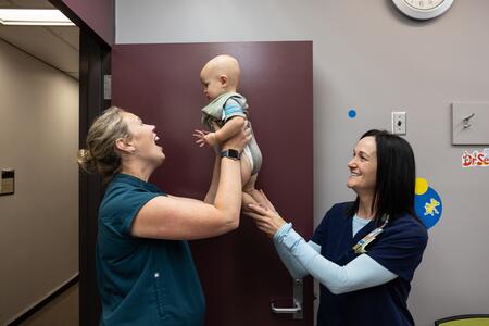 McBeain and Olesen play with an infant patient