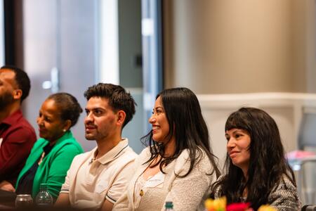 Attendees smile at a presentation at the Dental Therapy Banquet
