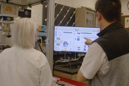 Alex Fok and Bonnie VanHeel watch the screen as the ART-5 works