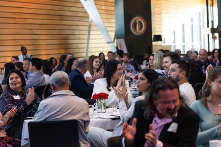 Attendees applaud and smile during a presentation at the DDS awards banquet
