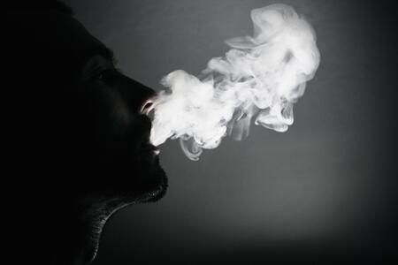 individual blowing smoke