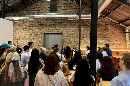 Attendees of the SAID conference listen to speakers at a networking event