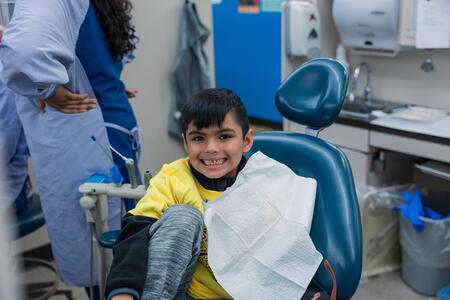 A child smiles while receiving treatment