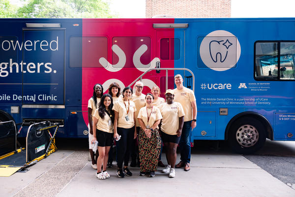 mobile dental clinic tour bus with team of eight people