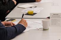 Close up of student taking notes at orientation