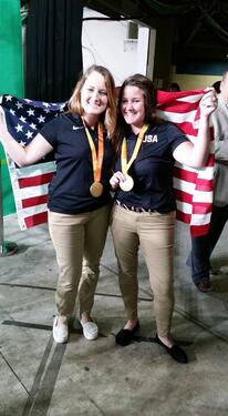 Kearstin Bisnett and other team lead with flag.