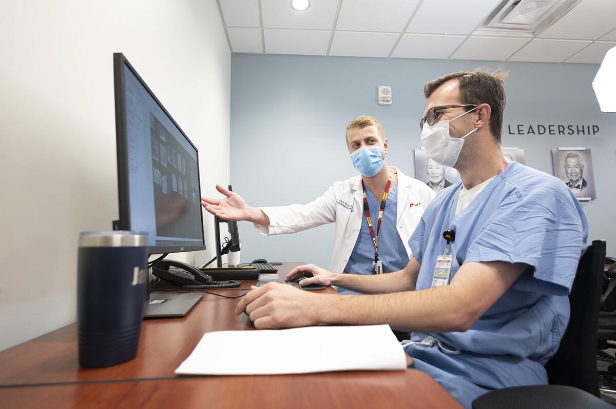 Two oral and maxillofacial surgery students view x-rays