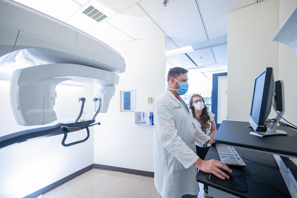 Dr. Robert Nadeau with a resident inside an Oral and Maxillofacial Surgery examination room