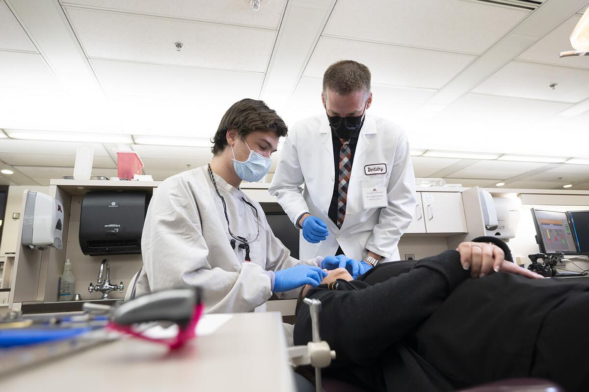 A professor and a resident discuss a case in the orthodontics clinic