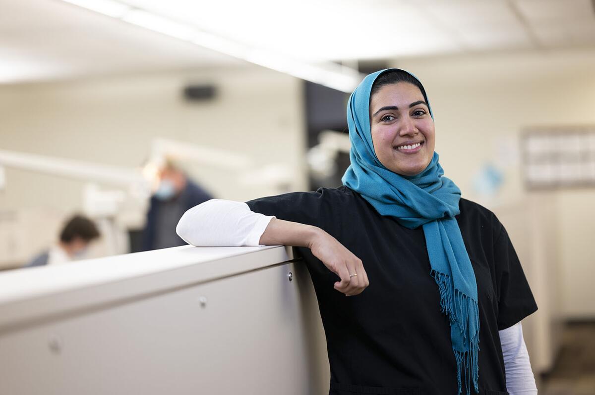 An orthodontic resident smiles in the orthodontics clinic