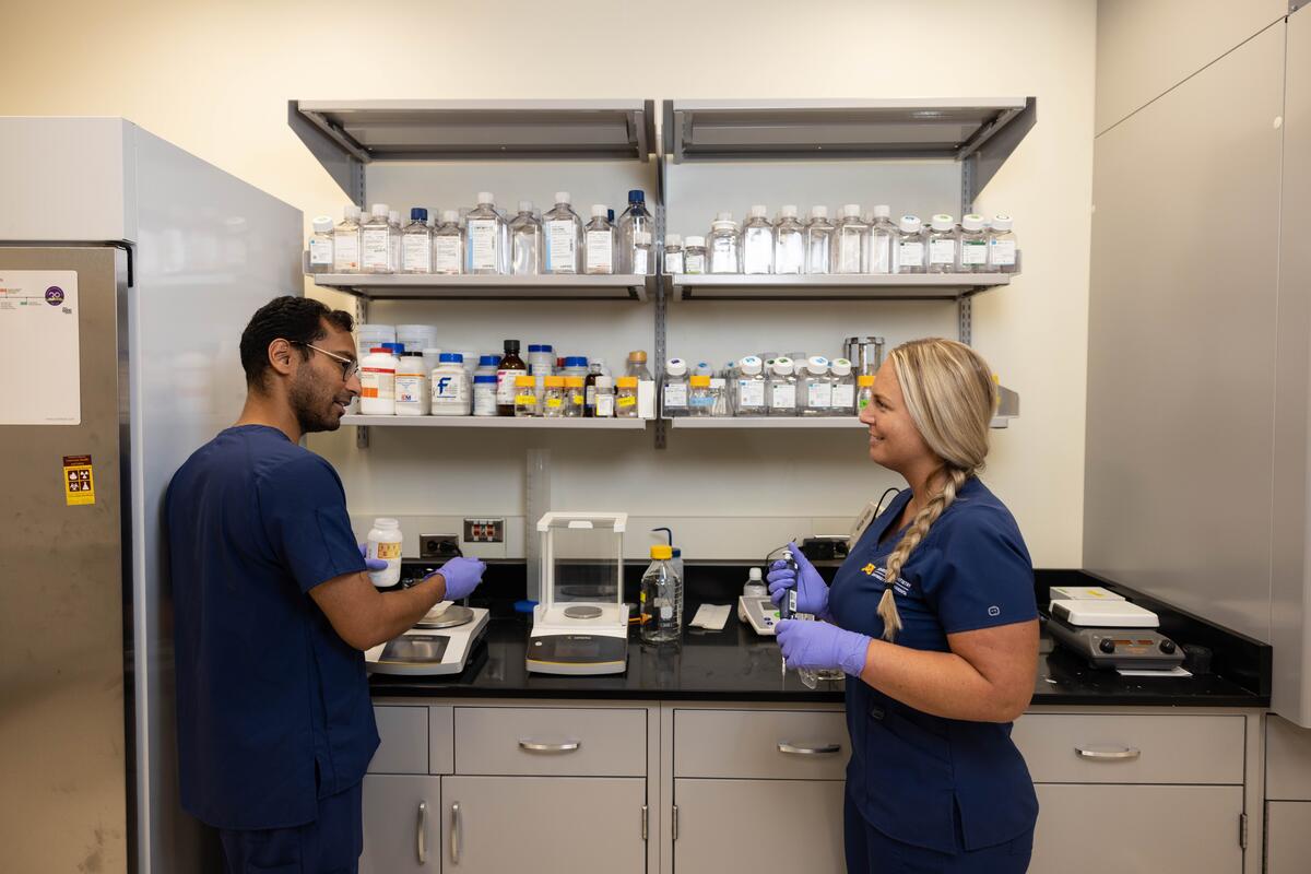 two students working on research in a lab