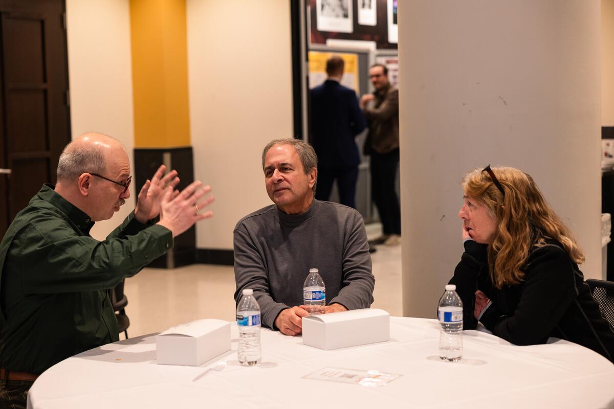 Attendees talk during a break at Research Day