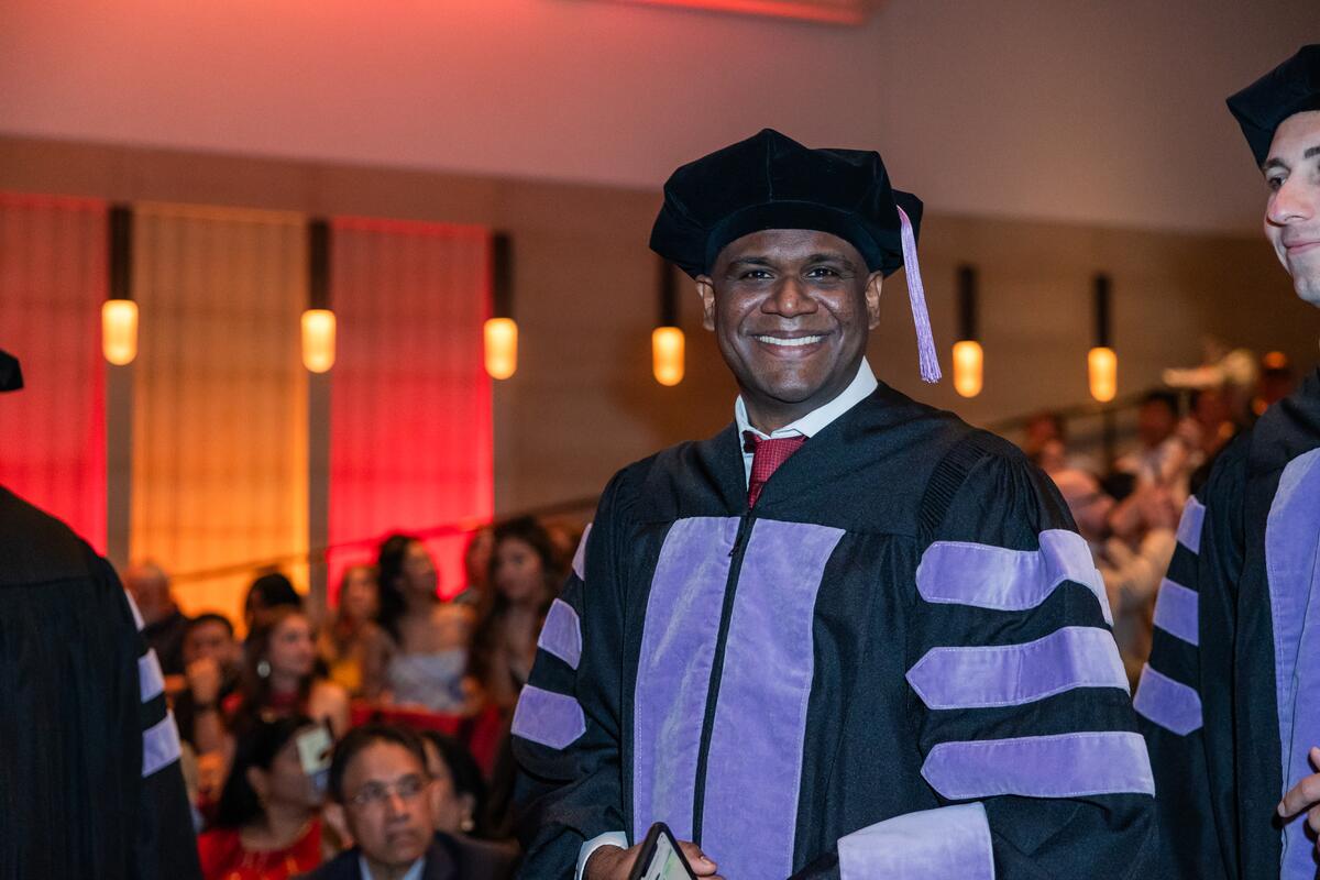 Sam Samaroo smiles as he enters the auditorium