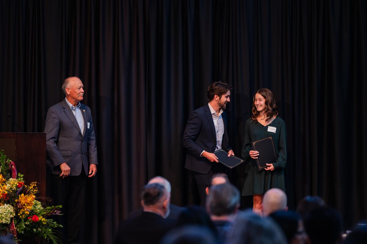 Students celebrate together with their awards onstage
