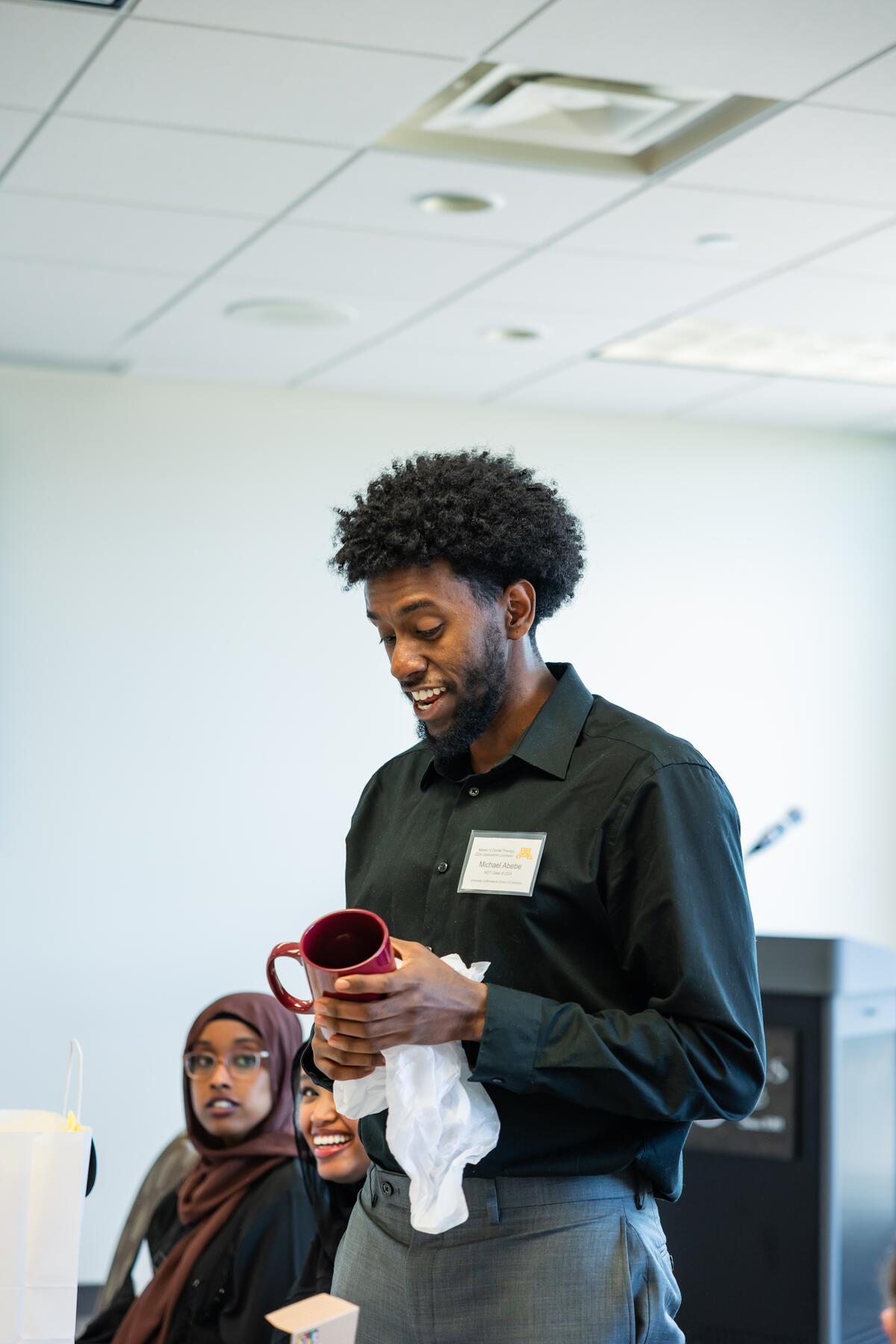 Michael Abebe opens a gift