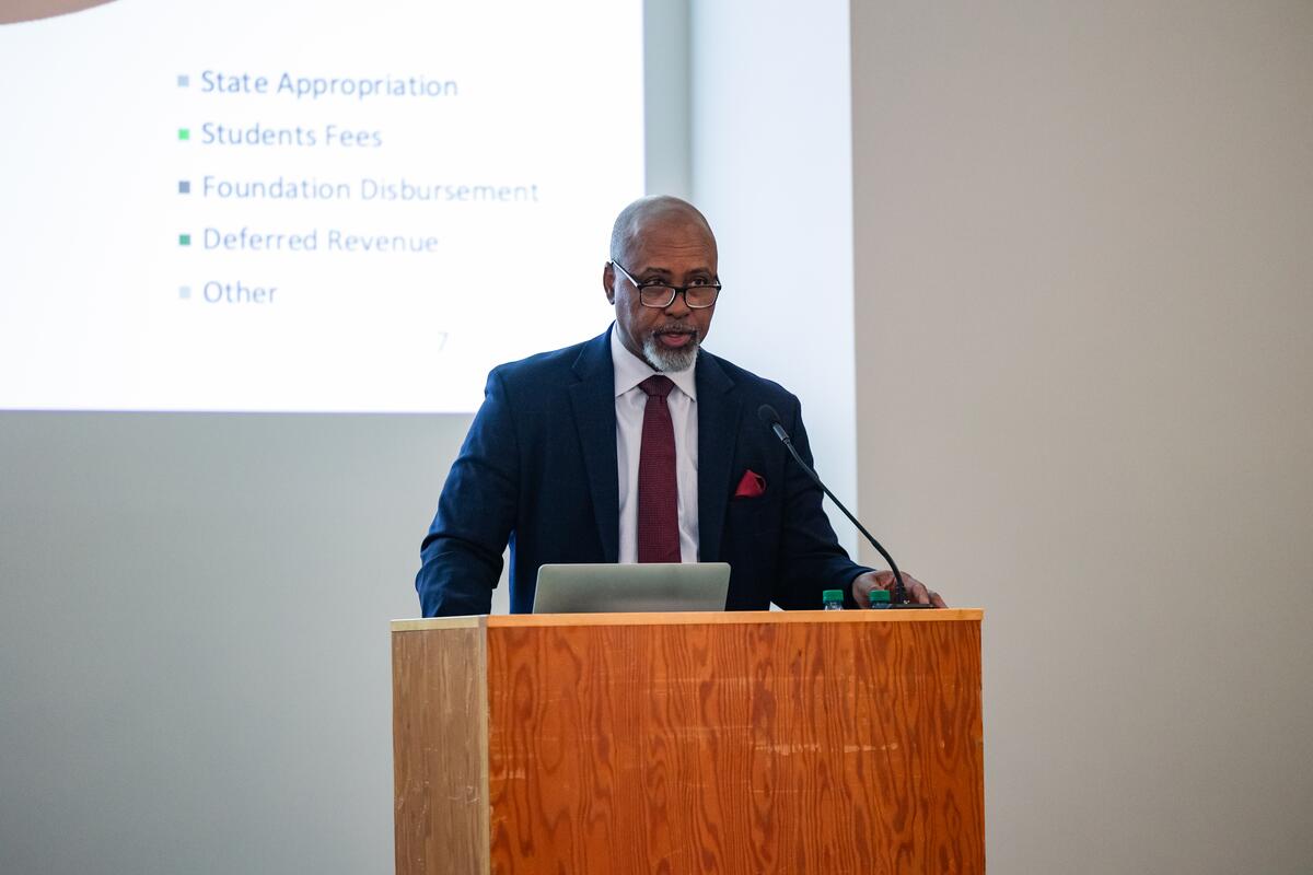 Dean Mays speaks from a podium 