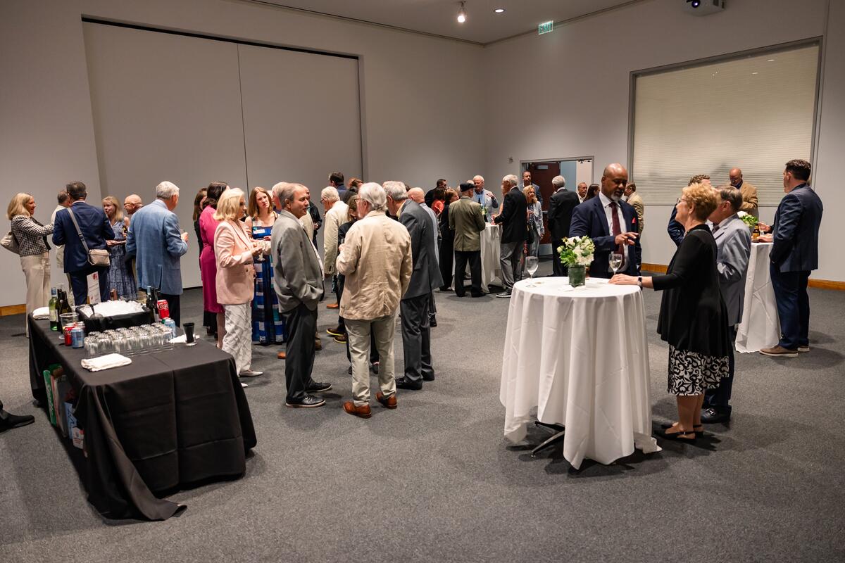 Wide shot of attendees at cocktail hour of Summer Celebration of Donors