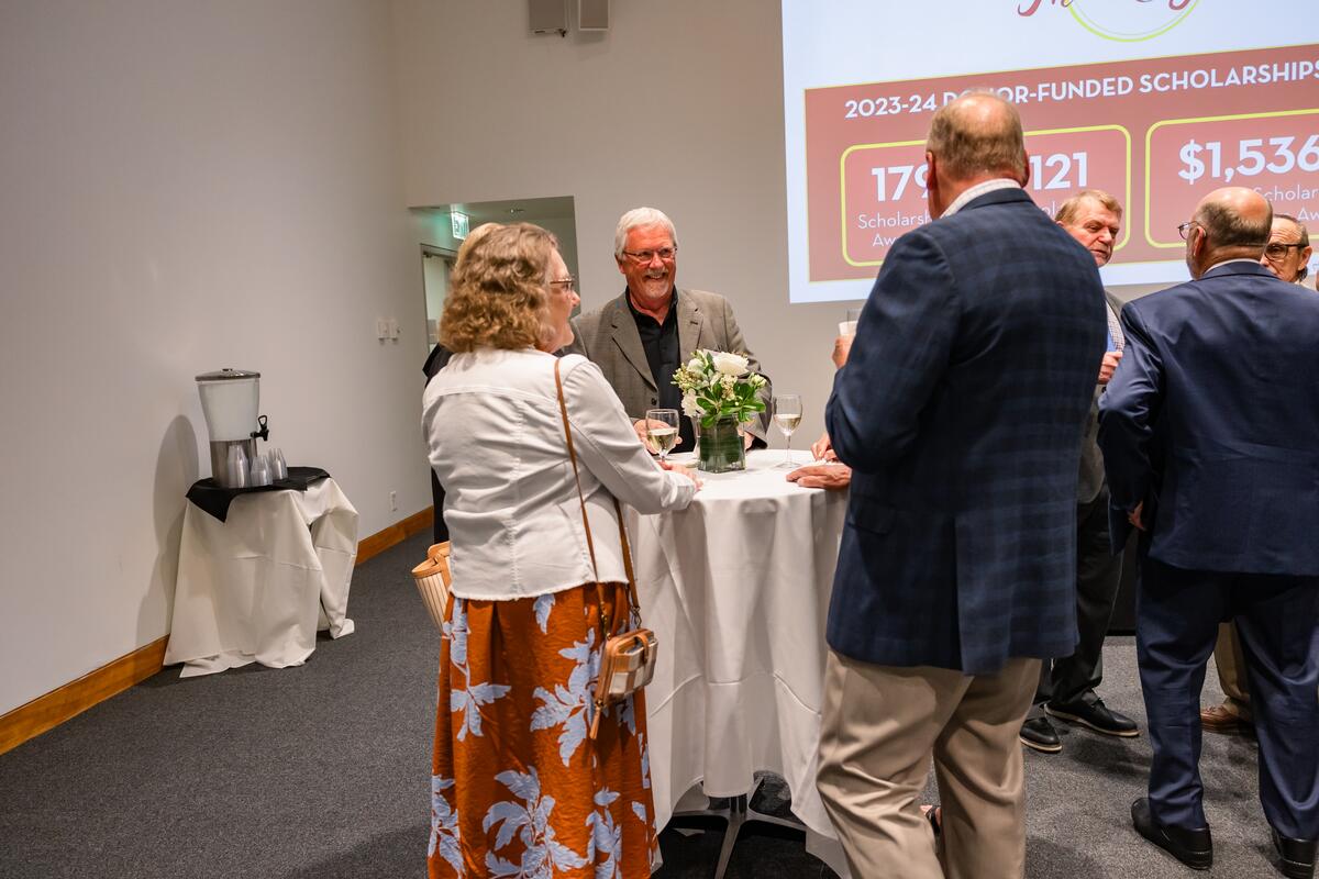 Attendees talk at the cocktail hour of the Summer Celebration of Donors