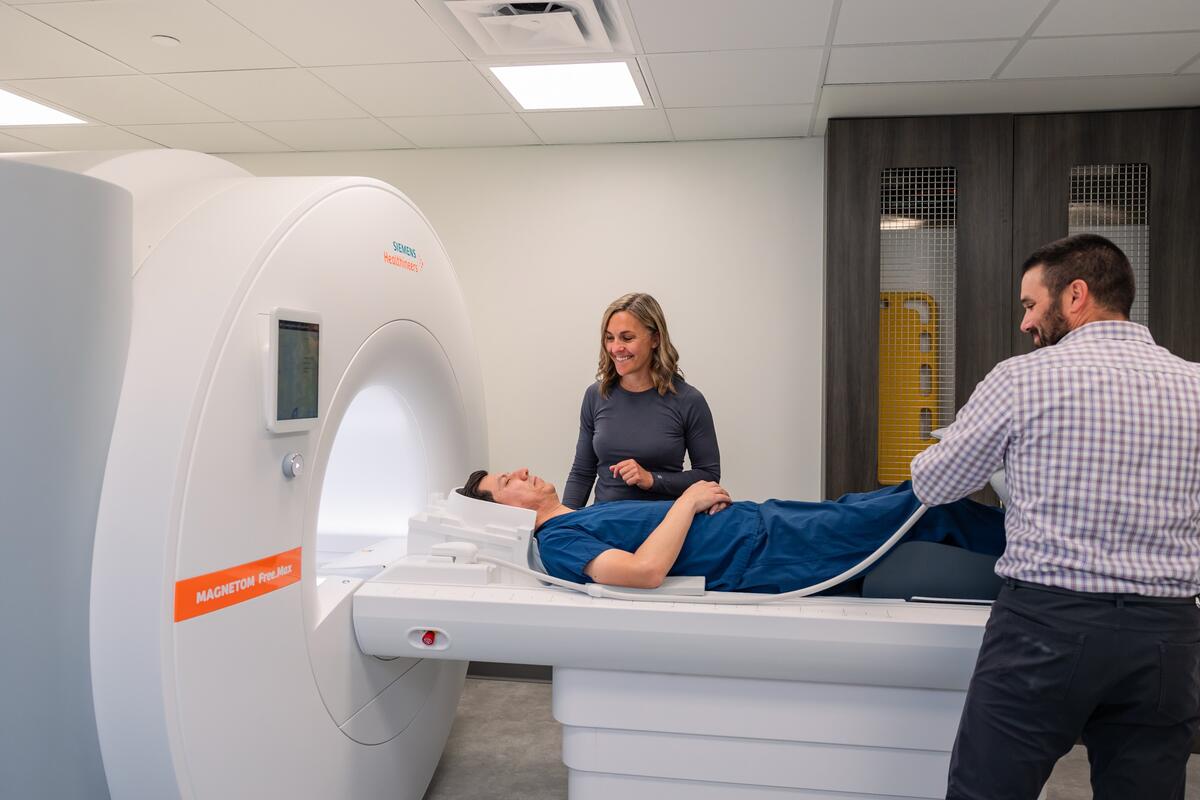Technician assists patient with MRI imagery