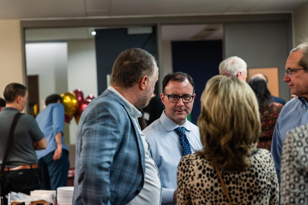 Rob Sellers speaks with other attendees at the OMRIC reception