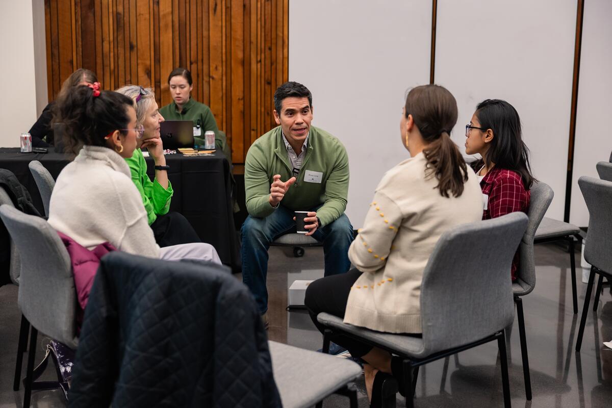 Faculty engaging in conversation at research retreat.