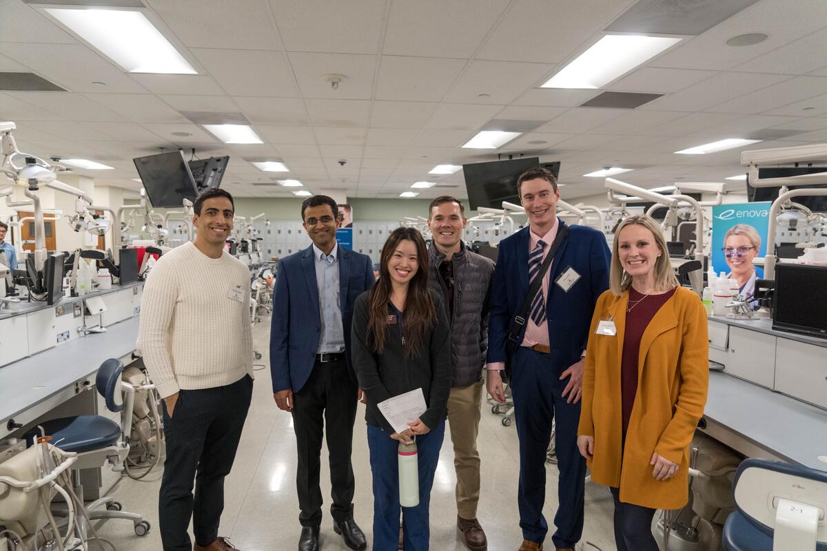 Guests standing in lab at alumni weekend.