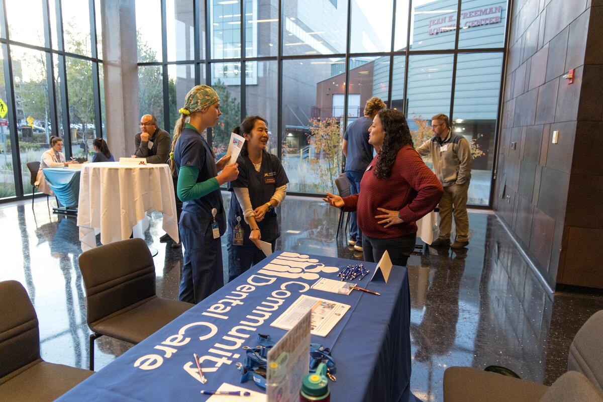 Guests at alumni weekend tabling.