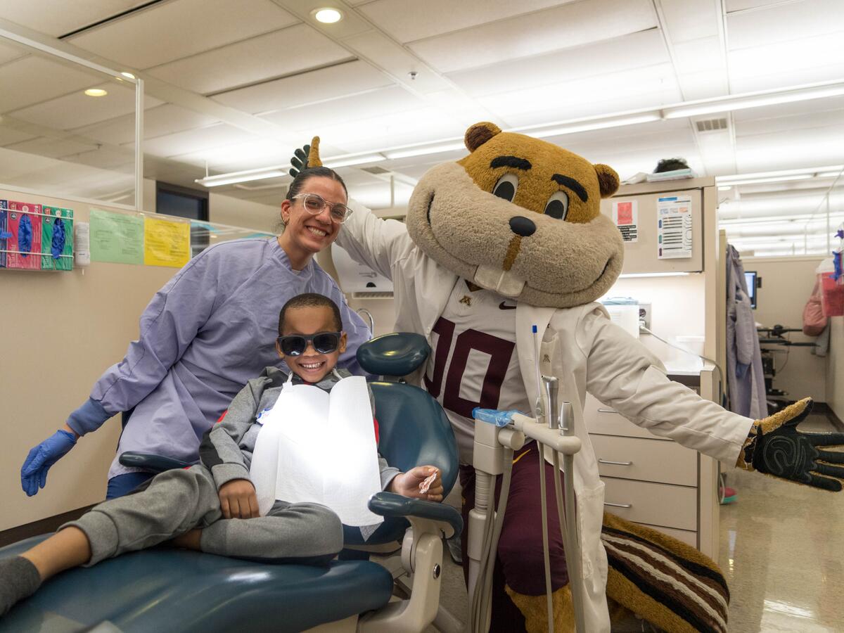 Goldy smiling with young patient.