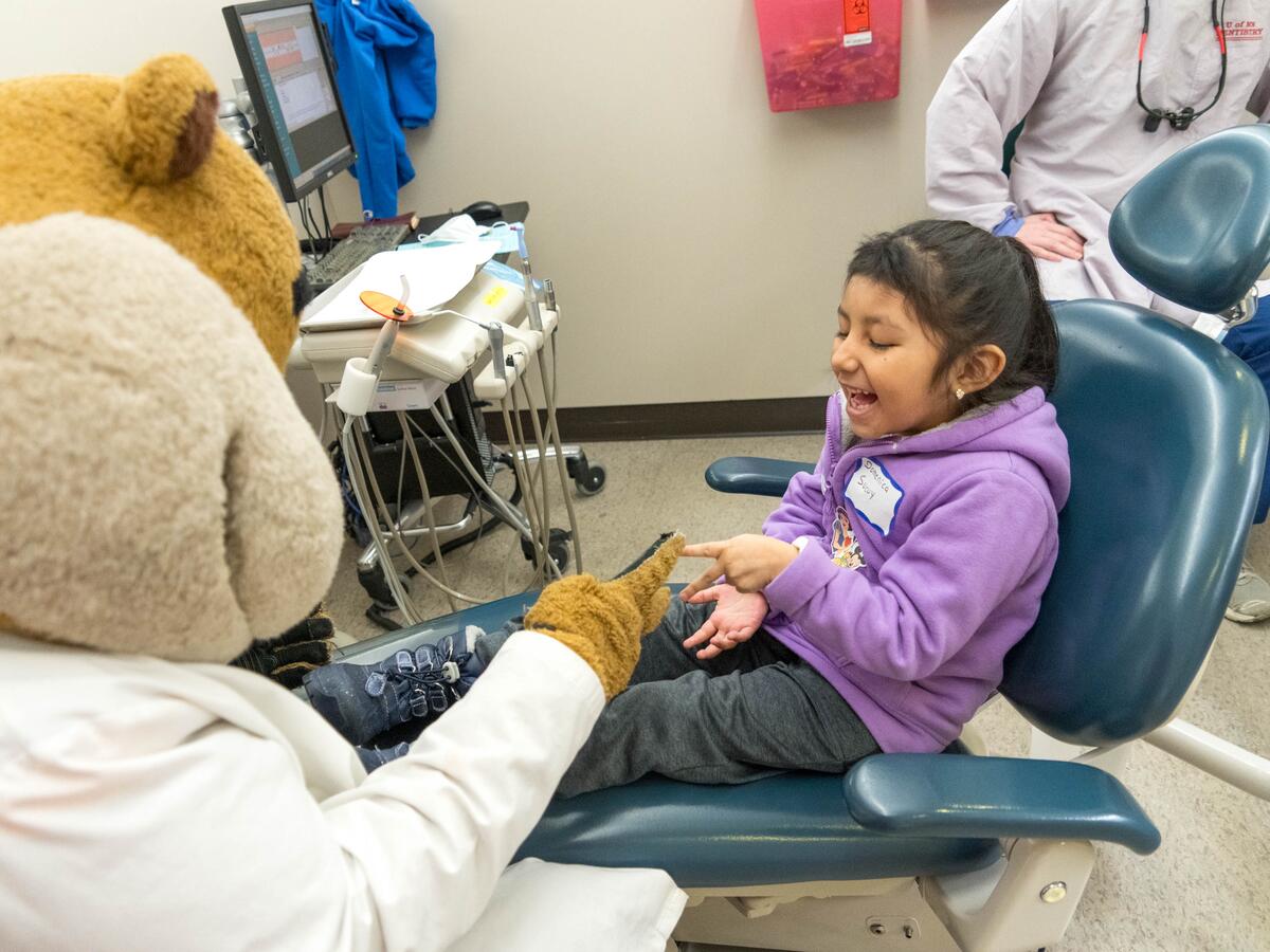 Goldy and young patient playing game together