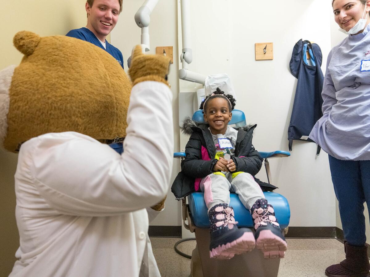 Patient smiling with Goldy.