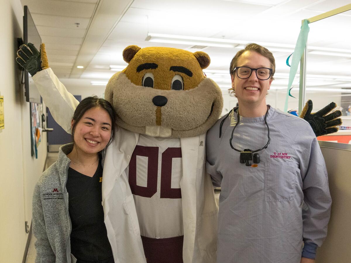 Goldy and residents smiling at event.