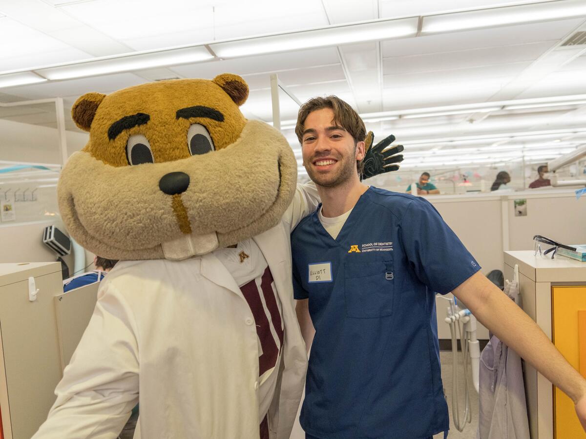 Goldy and student at give kids a smile event. 