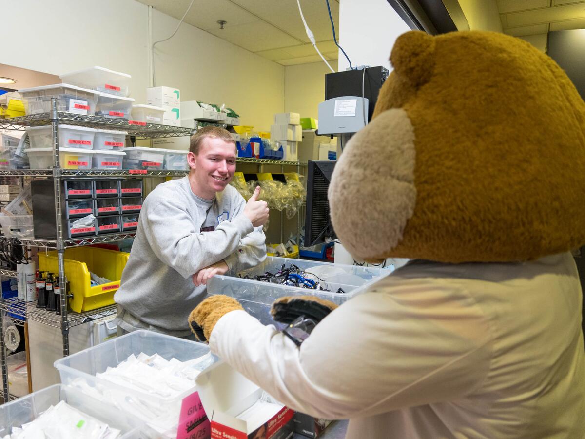 Goldy and volunteer at event.