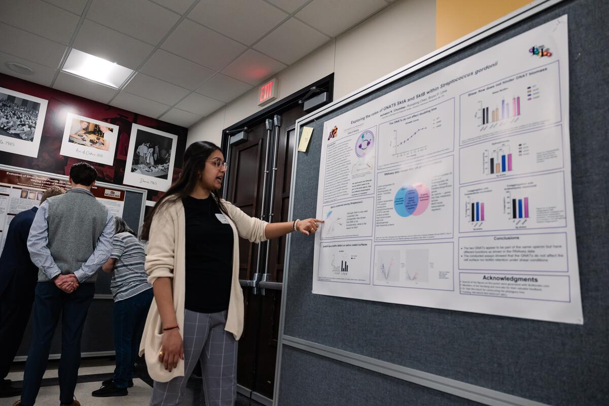 A student presents her research poster